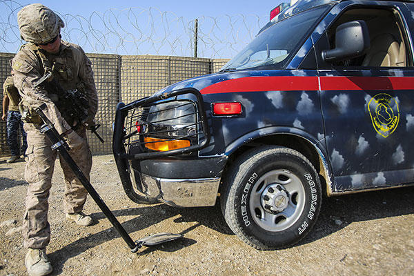 A U.S. Marine with Company B, 1st Battalion, 7th Marine Regiment, Special Purpose Marine Air Ground Task Force – Crisis Response – Central Command, searches an ambulance carrying an injured Iraqi soldier. (U.S. Marine Corps/Sgt. Ricardo Hurtado)