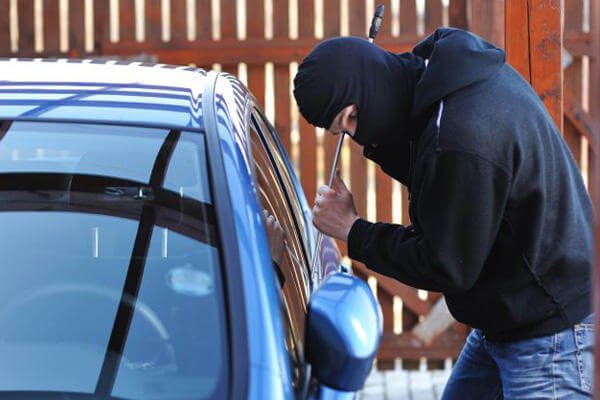 Car thief wearing a black hoodie.
