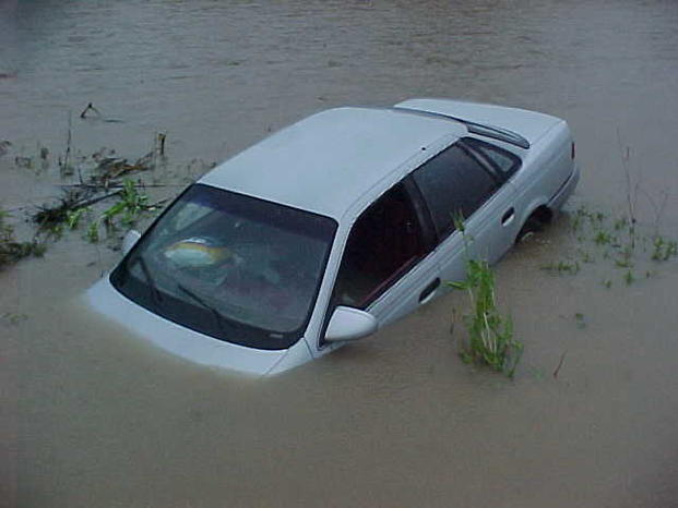 Silver car submerged in water.