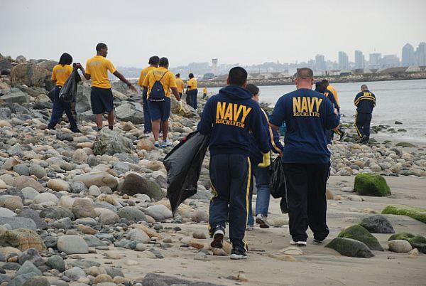 Sailors clean up a beach near San Diego