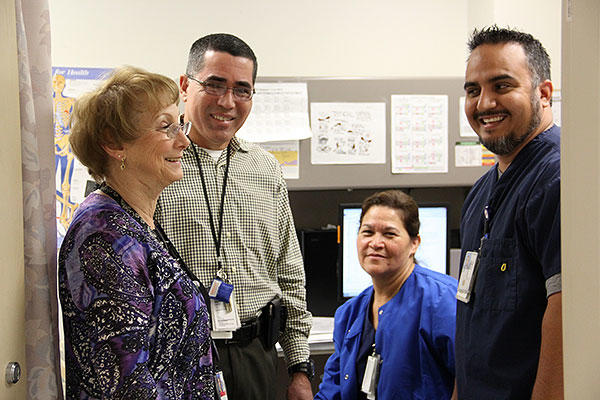 Col. Lenore Enzel, retired, left, Associate Director of Nurse and Patient Care Service at the El Paso, Texas, Department of Veterans Affairs, talks with nurses at the primary care clinic at the El Paso VA. (U.S. Army/Staff Sgt. Candice Harrison)