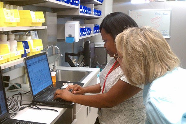 two nurses at a laptop (U.S. Army photo)
