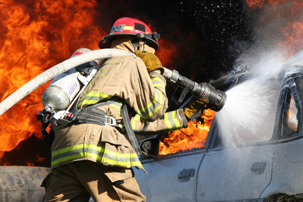 firefighter fighting fire with hose