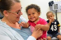 Chief Petty Officer Sylvia Pardoe and children visit Naval Branch Health Clinic (NBHC) Mayport’s Pediatrics clinic. (U.S. Navy/ Jacob Sippel)