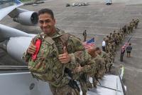 A 3rd Infantry Division soldier gives a thumbs-up as he boards a plane to deploy to Afghanistan on Aug. 3, 2017. The Pentagon says a recent surge has boosted the number of U.S. troops on the ground to 14,000. Staff Sgt. Candace Mundt/Army