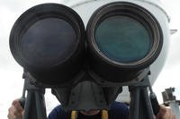 Coast Guard Seaman David Brink mans the binoculars as the Coast Guard Cutter Tampa prepares to anchor near the Panama Canal, Colón, Panama, July 27, 2017. (Coast Guard photo/Lisa Ferdinando)