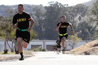 Sgt. George Ruiz, left, of the 49th Personnel Support Company, 115th Regional Support Group, California Army National Guard, battles Spc. Devon Witt to the finish line of the 2-mile run of the Army Physical Fitness Test. (Eddie Siguenza/Army National Guard)