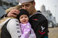 Electronics Technician 3rd Class Tyler Hernandez meets his child for the first time following the guided-missile cruiser USS Vella Gulf's (CG 72) return to homeport. (U.S. Navy/Justin Wolpert)