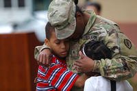 A soldier says goodbye to her children before her 9-month deployment. (U.S. Army/Ian Ives)