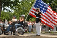 Retired Staff Sgt. Tim Chambers stands at attention and salutes as motorcycle-riding veterans pass during the 25th annual Rolling Thunder motorcycle rally in 2012.