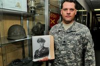 In this 2015 photo, Staff Sgt. Joshua Conner holds a photograph of his relative, 1st Lt. Garlin Murl Conner. According to various news reports, Lt. Conner was the second most- decorated soldier who fought in World War II. (US Army photo/David Lietz)