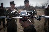 A Marine holds up an MK-2 Instant Eye quadcopter unmanned aerial system during exercise Spring Storm 2018, Capu Midia Training Area, Romania, March 10, 2018. (U.S. Marine Corps photo/Austin Livingston)