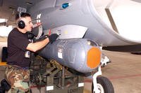 Tech. Sgt. Marcos Farias attaches a Low-Altitude Navigation and Targeting Infrared for Night targeting pod to a 149th Fighter Wing F-16 Fighting Falcon at Lackland Air Force Base. (U.S. Air Force photo/Mike Arellano)