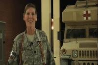 A screenshot from a 2011 video shot in Kandahar, Afghanistan shows then-Navy Cmdr. Lynne Blankenbeker sending Christmas greetings to family back home. Blankenbeker is now running for Congress in New Hampshire. (DVIDS)