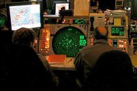 After Sept. 11, 2001, this is what the NEADS operation floor looked like. Above the Q-93 (the large green radar scope) is the NORAD contingency suite that was installed immediately after 9/11 to provide radar data of the entire country. Photo courtesy of Master Sgt. Stacia Rountree, Eastern Air Defense Sector