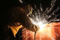 A soldier with the 937th Route Clearance Company, 36th Engineer Brigade, uses a welding tool while working along the border wall in Lukeville, Arizona, on Nov. 15, 2018. (U.S. Army Photo by Pfc. Bradley McKinley)