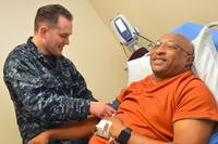 Hospitalman Payton Dupuis checks veteran Joseph Levette’s blood pressure at Naval Hospital Jacksonville’s internal medicine clinic, May 10, 2018. (U.S. Navy photo/Jacob Sippel)