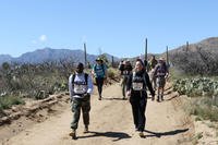 U.S. Army Reserve 1st Lt. Sylvia Orozco, with the 383rd Quartermaster Battalion, and Capt. Roxanna Flores and Sgt. Desiree Lopez with the 356th Transportation Company, approach mile marker 8 on the 26-mile Bataan Memorial Death March at White Sands Missile Range, New Mexico, Mar. 17, 2019. (U.S. Army Reserve photo/Brandon R. Mace)