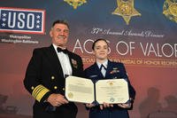 Coast Guard Commandant Adm. Karl Schultz poses with Petty Officer Traci Huddleston, first recipient of the Coast Guard Medal for heroism since 2012. (Courtesy USO)