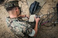 A satellite communication operator with the Special Purpose Marine Air-Ground Task Force Crisis Response Central Command 19.1, adjusts a ground antenna transmit and receiver satellite transformer during an exercise on Marine Corps Base Camp Pendleton, Calif., Sept. 11, 2018. (U.S. Marine Corps/Cpl. Jeremy Laboy)