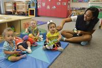 Danielle Gatlin, 56th Force Support Squadron Child Development Center assistant teacher, watches children during recess at the CDC at Luke Air Force Base. The Defense Department has changed some rules to make it easier for military spouses to get jobs at duty locations. (U.S. Air Force photo by Senior Airman Devante Williams)