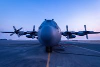 A C-130 deployed from the Montana Air National Guard's 120th Airlift Wing sits on the ramp as the sun sets at Ali Al Salem Air Base, Kuwait, on July 29, 2019. (U.S. Air Force Photo by Tech. Sgt. Michael Mason)