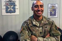 Spc. Juan Gonzalez, a scout with Headquarters and Headquarters Company, 1st Battalion, 32nd Infantry Regiment, 1st Brigade Combat Team, 10th Mountain Division (LI), poses for a photo at the 1-32IN 24-hour gym where Gonzalez trained hard enough to become the 1st enlisted Soldier to max out the new Army Combat Fitness Test with a score of 600. (James Avery/U.S. Army)