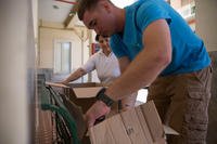 A Marine unloads boxes.