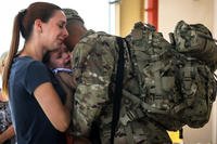 A military family hugs before deployment.