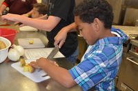 kids cutting fruit with supervision