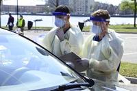 Patients undergo screening  in their car at Naval Medical Center Portsmouth.