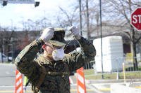 Lance Corporal Wayne Parsons, assigned to II Marine Expeditionary Force, dons a face mask