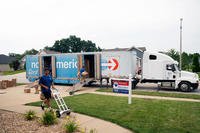 Movers pack a military member’s property into boxes