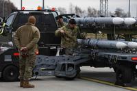 U.S. Air Force weapons loaders pick-up an AIM-120 missile during an Agile Combat Employment exercise, at Spangdahlem Air Base.