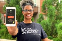 woman holding phone with app displayed