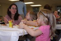 woman and children eating dinner