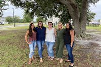 group of women standing outside