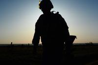 The silhouette of a soldier as he runs to the turnaround point of a 12 mile ruck march.