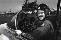 Mark Fox poses in a Hornet aboard the USS Saratoga.