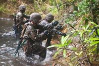 Marines from 1st Squad, 3rd Platoon, Alpha Company, climb out of a river during an endurance course.