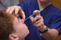 Ear Nose and Throat Clinic otolaryngologist examines student.