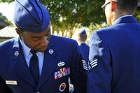 U.S. Air Force staff sergeant inspects uniform