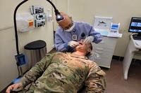 Dentist with reservist in chair