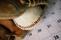 baseball glove on top of calendar