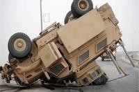 A Mine-Resistant Ambush-Protected vehicle rests on its turret and hood