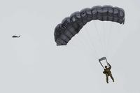 Paratrooper lands after conducting HALO parachute training