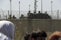 U.S. soldiers stand guard inside the airport walls in Kabul