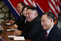 North Korean leader Kim Jong Un smiles during a meeting
