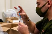 U.S. Navy Corpsman prepares a vaccination at the U.S. Naval Hospital Okinawa on Camp Foster