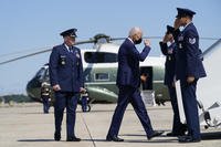President Joe Biden returns a salute as he walks to board Air Force One.